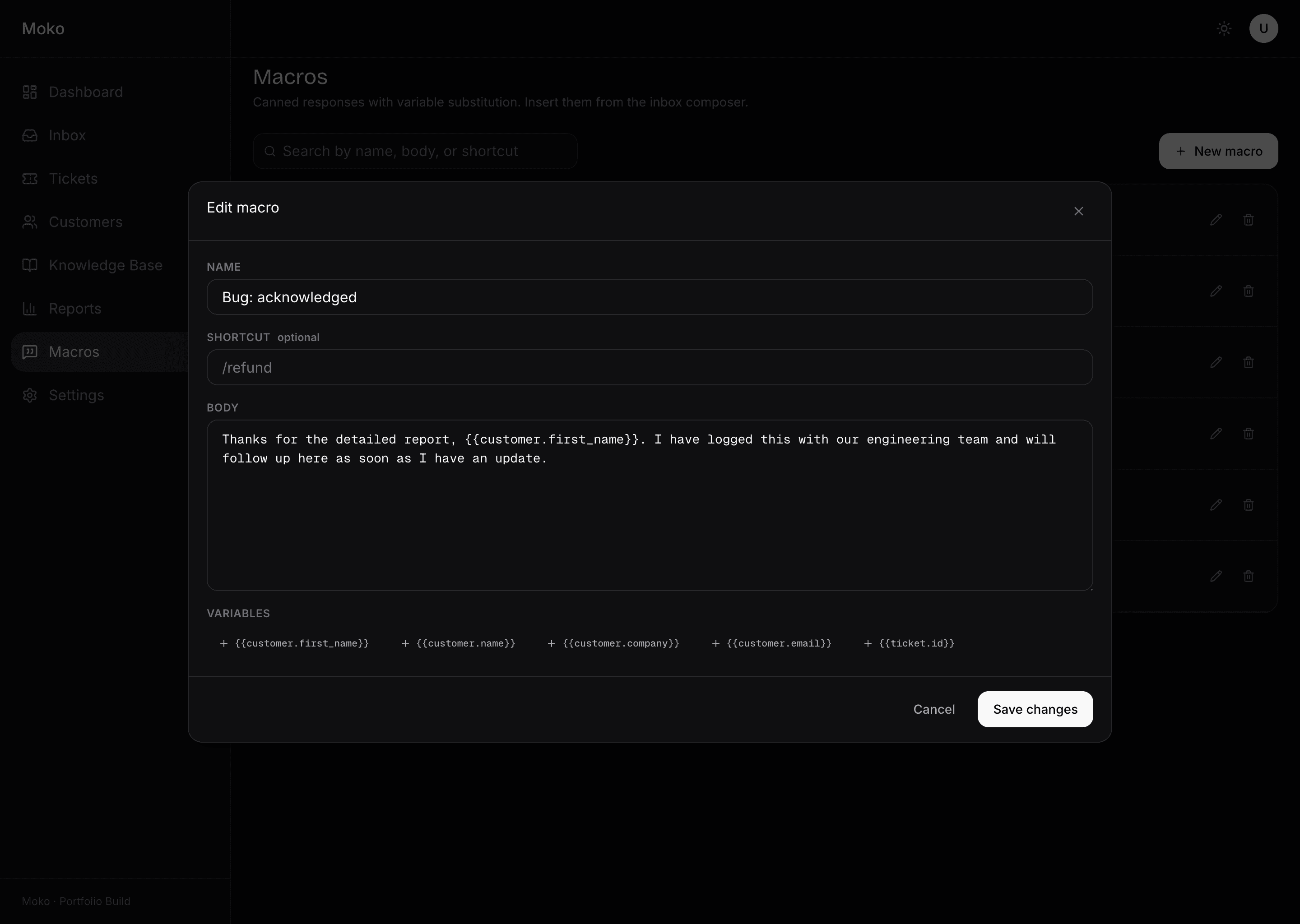 Moko macro edit modal. Form with name field, optional shortcut, body textarea, and a variable picker offering customer first name, customer name, customer company, customer email, and ticket id. Cancel and Save changes buttons.